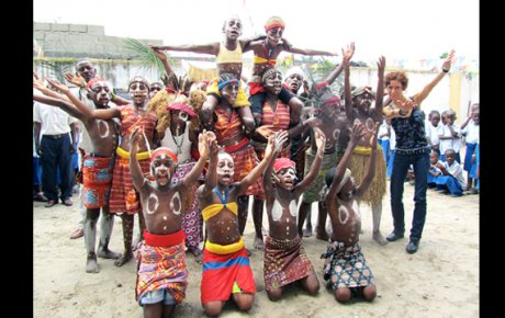 Carmen Smith poses with school children in the Democratic Republic of Congo who performed for her visit.