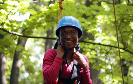 Anita smiles proudly when completing a challenging high ropes course during her exchange.