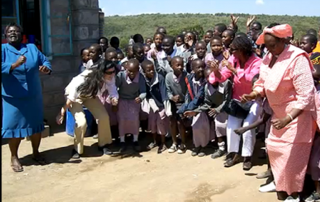 Maasai women and children greet American visitors.