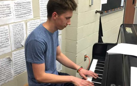 Young man playing a piano