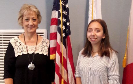 Older woman standing next to a teenaged girl