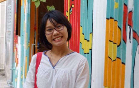 Head shot of young woman smiling with colorful background