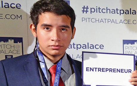 Young man holding a card that reads Entrepreneur