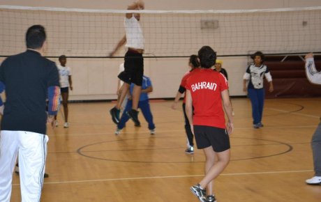 The female volleyball coaches take part in a friendly game with Americans. 