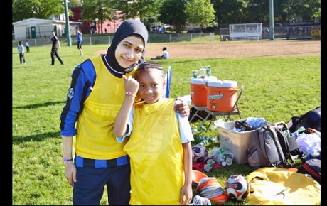 An Egyptian soccer coach poses with another participant at a United for DC volunteer session.