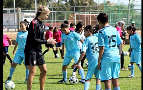 Marian Dalmy shares tips on soccer techniques with young players in Morocco.
