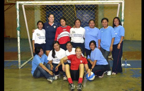 Soccer Envoys Tracy Noonan and Shannon MacMillan pose with girls in Solala, Guatemala.