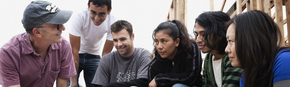 Student volunteers helping to build a house