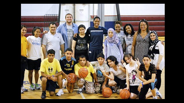 The Iraqi participants pose with Monica McNutt, Georgetown University basketball player.