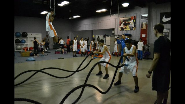 Participants work with expert basketball skills coach Stan Brudish on dribbling techniques.