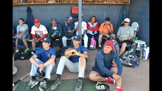 During a time-out, the young coaches receive a history lesson about the World Baseball Classic. 