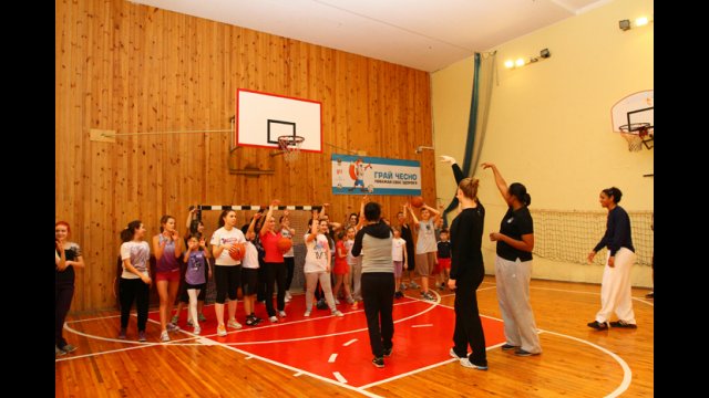 Sports Envoys Tamika Raymond and Nykesha Sales work with NBA representative Becky Bonner to lead an exercise focused exclusively on three-pointers.