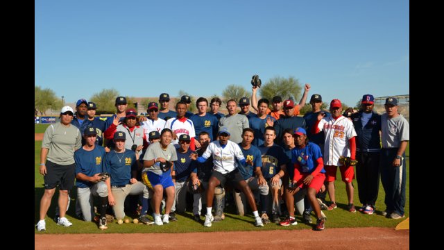 The Dominican Republic and Venezuelan visitors gather with their MLB counterparts after a full day out on the field.