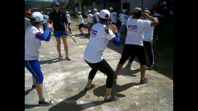 Teenage softball players from Nicaragua work on batting stances after receiving key instructions from Jess Mendoza. 