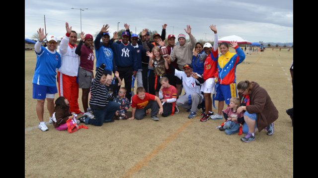 The coaches pose with representatives of a local-area sports group.