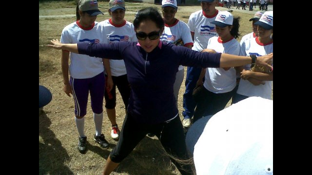 Ruby Rojas demonstrates warm-up techniques to a group of Nicaraguan softball players.