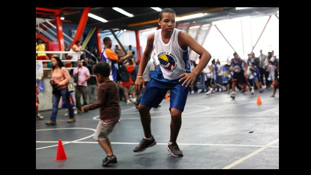A clinic participant is joined on the court by a friend.