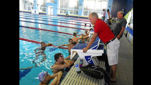 Coach Alex, originally from Belarus, coaches both the American swimmers and the Russian swimmers.