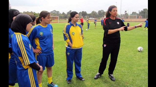 Coach Lesle Gallimore shares a game strategy with a group of Moroccan players.