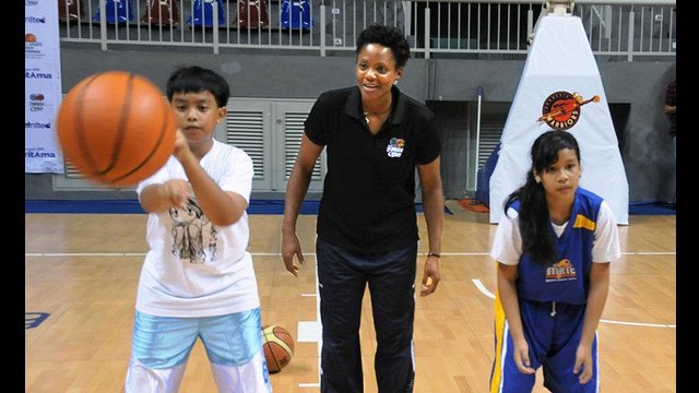 WNBA Champion Edna Campbell focuses on hand-eye coordination drills with young players during a clinic.