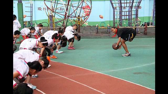 The girls do more basketball dribbling techniques with Kiesha Brown.