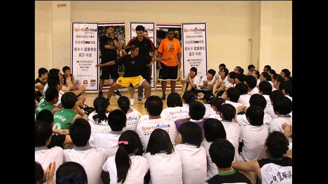 Kiesha Brown demonstrates a blocking pose for students during a Q&amp;A session.