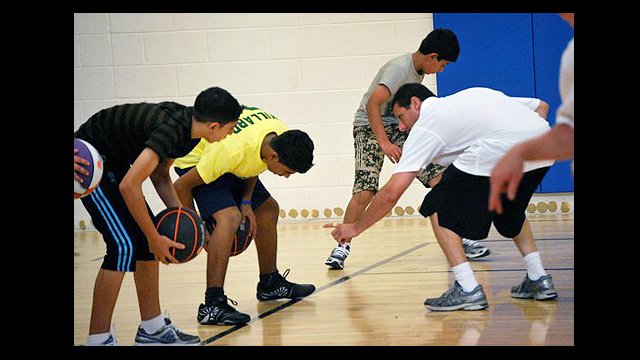 Coach Issacson coached the participants through a traditional American basketball practice.