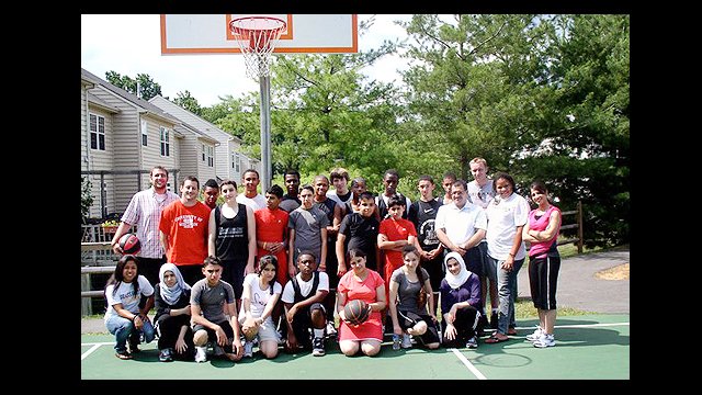 The group poses with some American basketball players.