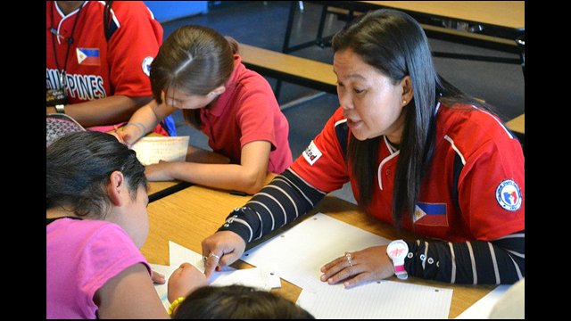 A Filipina coach helps a student during class at a local Phoenix-area school.