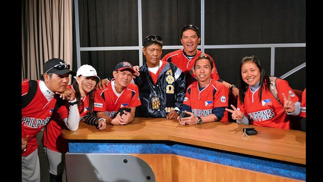 The group poses in the media center of a local high school.