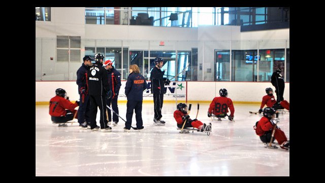 The Washington Sled coaches and Russian hockey coaches plot out their scrimmage