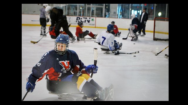 The Russian visitors try out their sledding skills.