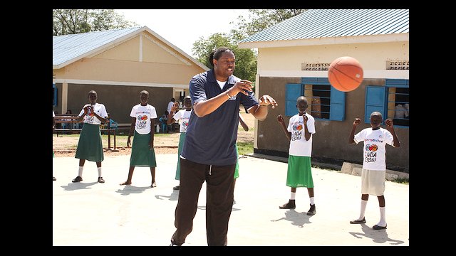 NBA Legend Sam Perkins leads the girls in a passing drill.