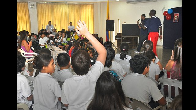 Barry Larkin and Joe Logan interact with girls and boys at Colegio Americano in Ecuador.