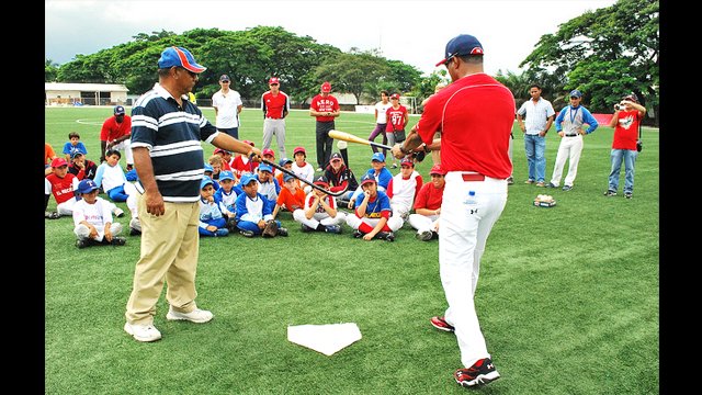 Barry Larkin works on batting with an Ecuadorian coach and his team at Yeyo Uraga, a sports complex in Guayaquil.