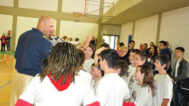 Tracy Murray gives high-fives to his fans in Greece.