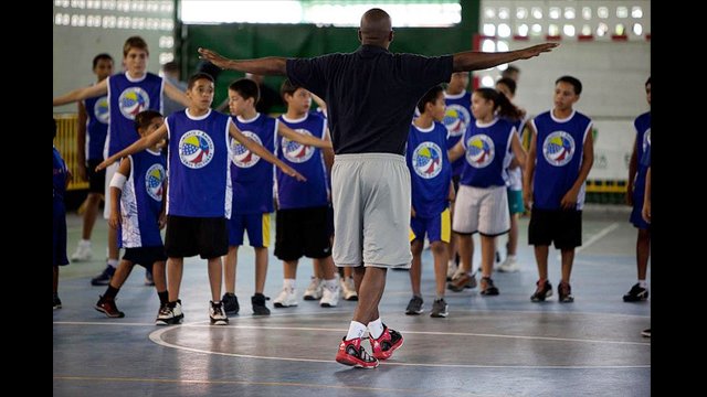 Chris Clunie, Senior Coordinator for the NBA&#039;s International Basketball Operations, leads warm-up with the young Venezuelans.