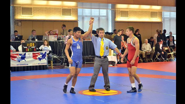 A Mongolian wrestler wins a match.