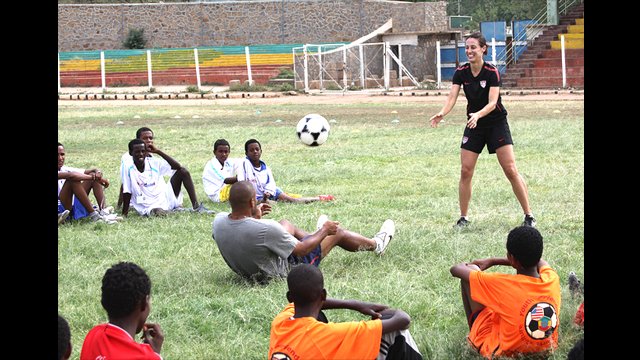 Kate Markgraf and Tony Sanneh demonstrate teamwork through header drills.