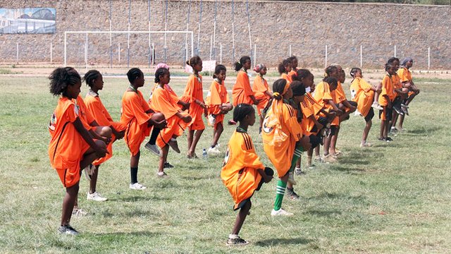 Young Ethiopian girls stretch before their soccer scrimmage in Dire Dawa, Ethiopia.