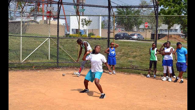 The participants practice their shot put skills.