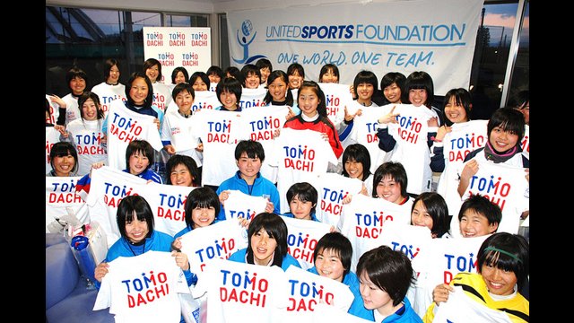 These young girls hold up their &quot;TOMODACHI&quot; shirts to represent the initiative to strengthen the friendship between Japan and the U.S.