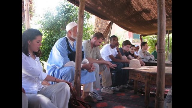 NSLI-Y scholars rest under a tent and prepare for tea