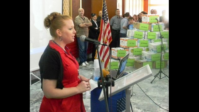 Fulbright English Teaching Assistant Jennifer Birdsall speaking at the American Corner Tetovo, where the 14,500 English books collected through donations were distributed. The pyramid of books can be seen in the background.