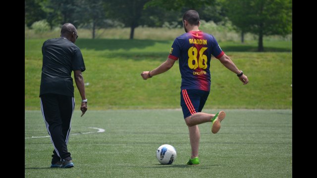 U.S coach/trainer works with a NEA coach on a passing drill.