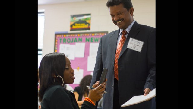 Photo of TEA participant Siby Sebastian helping a student with algebra