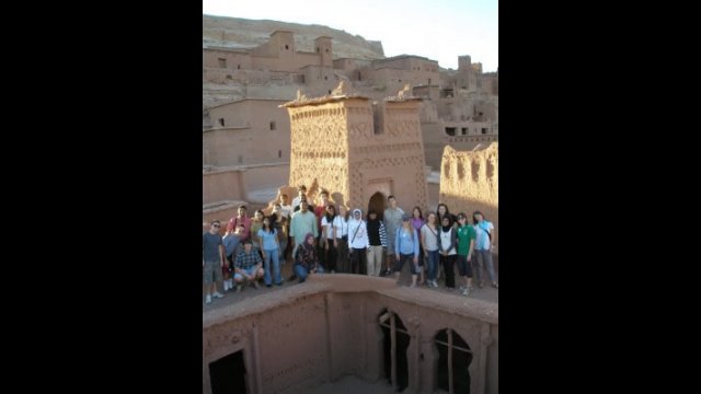 NSLI-Y scholars pose in front of a tower at Aït Benhaddou.