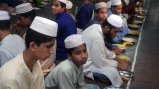 Young men gather in a madrassa for the evening meal called Iftar to break their fast durning the month of Ramadan. Kala Chandpur, Dhaka