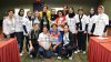 The delegation poses with Kathy DeBoer of the American Volleyball Coaches Association after a session on gender and competition.