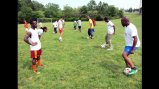 Swaziland coaches practicing with the varsity soccer team from C.D. Hylton High School.